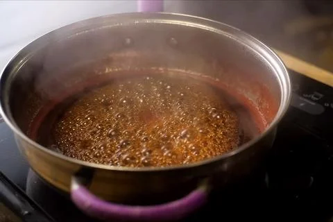 Boiling jam, jam to jam. boiling on fire in steel plate. Stock Photos