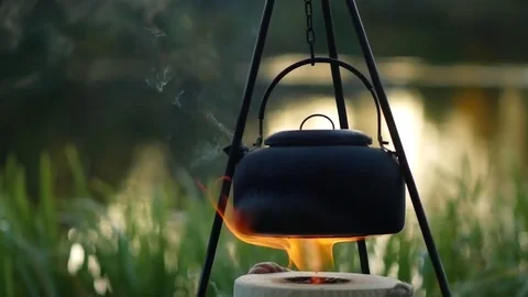 Boiling kettle on the fire outdoor slow motion Stock Footage 81756173