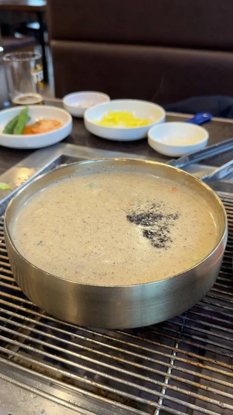 Boiling Korean Perilla Seed Soup in Brass Bowl Stock Footage 337567009