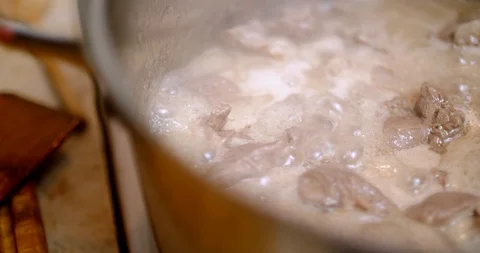 Boiling lamb meat in a saucepan Stock Footage 88046988