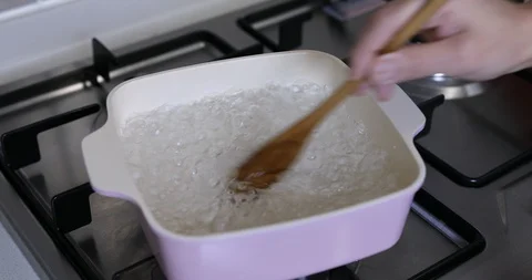 Boiling lotus root in pot to cook Stock Footage 120109354