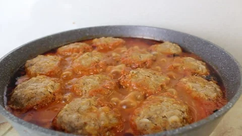 Boiling meatballs in a frying pan close-up side view Stock Footage 323898503