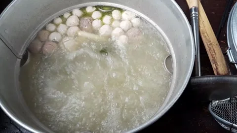 Boiling meatballs in savory broth — close-up food cooking Stock Footage 323591714