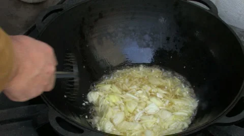 Boiling melted fat with onion Stock Footage 960380