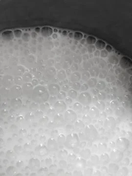 Boiling milk in a pan. Stock Photos