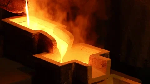 Boiling molten gold flows into a special form. Video shot close up. Stock Footage 122212001