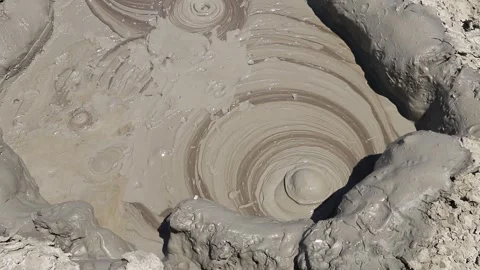 Boiling mud bubble bursting inside a mud volcano crater Stock Footage 339270038