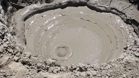 Boiling mud bubble bursting inside a mud volcano crater Stock Footage 339270054