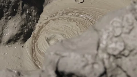 Boiling mud bubble bursting inside a mud volcano crater Stock Footage 339270058