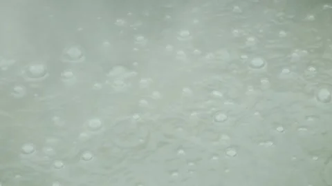 Boiling mud bubbles and hot steam in geyser Video stock 319907936