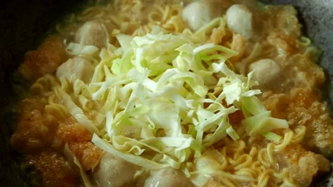 Boiling noodles with cabbage in pot, in door  Chiangmai  Thailand. Stock Footage 246273463