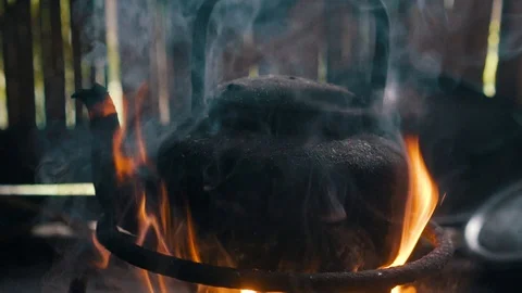 Boiling old kettle on the fire with steam Stock Footage 97047534