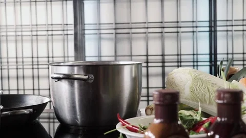 Boiling pan on the burner among vegetables Video stock 73213224