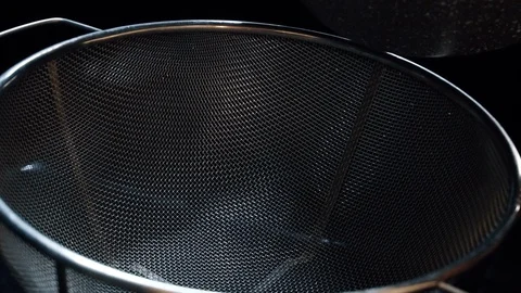 Boiling pasta. Draining macaroni water through a colander in the sink. Stock Footage 122560050