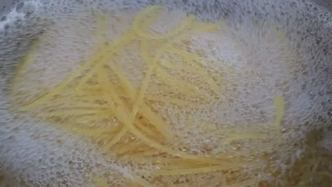 Boiling pasta in a pot full of hot water and salt. Spaghetti. Stock Footage 305041649