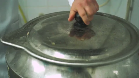 Boiling pork ears for use in making sausages in a meat factory. Part of sausage Vídeos de archivo 131858313