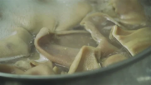 Boiling pork ears for use in making sausages in a meat factory. Part of sausage 库存影片 131858607