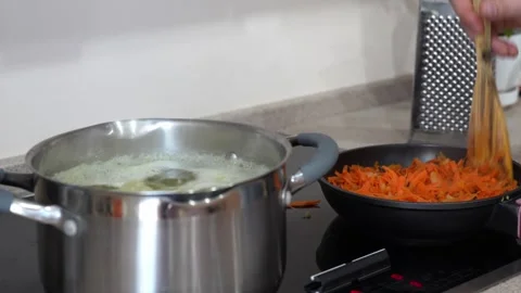 Boiling pot and sautéing vegetables in a pan Stock Footage 301290764