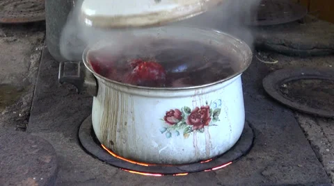 Boiling pot with beet vegetable on old furnace Stock Footage 37923971