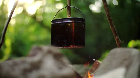 Boiling pot on the fire. Cooking outdoor food in tourist spot at bonfire. Video stock 97184585