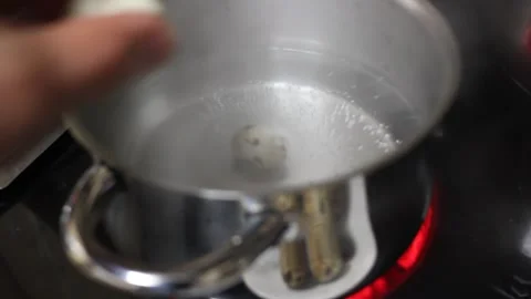 Boiling Quail Eggs in a Pot of Hot Water Stock Footage 347393672
