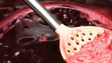 Boiling red currant jam bubbles in a saucepan. Stock-Footage 337676907