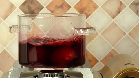Boiling red Easter eggs in a glass pot 스톡 동영상 270708905