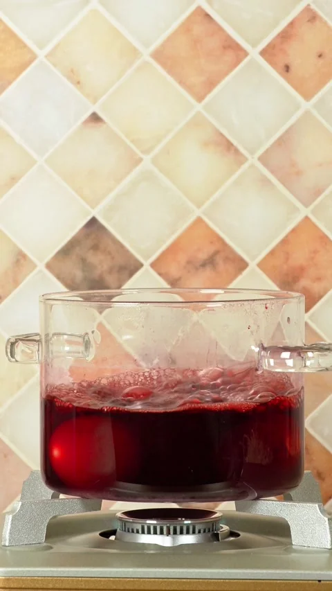 Boiling red Easter eggs in a glass pot 스톡 동영상 270708918