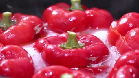 Boiling red stuffed peppers recipe close up Stock-Footage 247774259