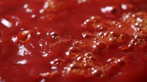 Boiling red tomato sauce in a pan with steam for making pizza or pasta Stockbeeldmateriaal 137903701