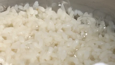 Boiling rice. Macro footage of boiling grain. Isolated, close-up shot Video stock 118846338