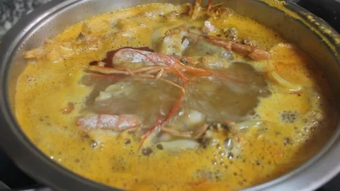Boiling shrimp shells and fish to make a broth for the rice Stock Footage 260226330