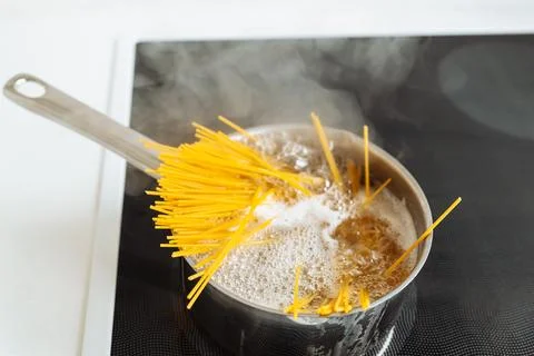 Boiling spaghetti in boiling water Stock Photos