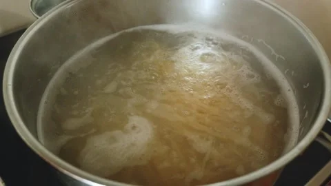 Boiling spaghetti in pot with gently bubbling water, 23.976fps Stock Footage 311774658