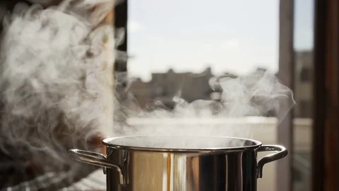 Boiling stainless pan under high temperature. White steam rising from the pot Stock-Footage 117352571