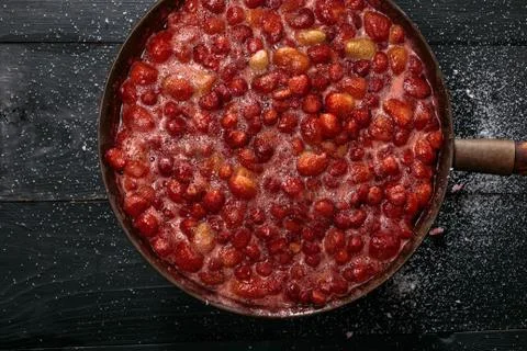Boiling strawberry jam Stock Photos