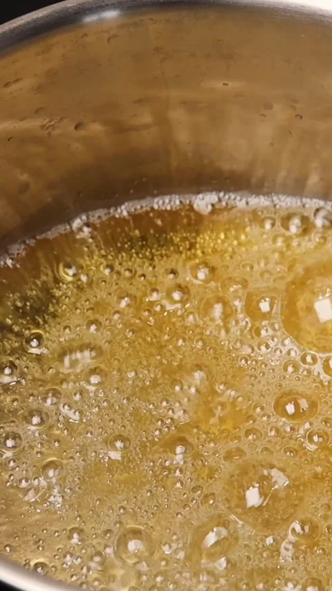 Boiling sugar to make syrup for desserts. Thick, bubbling syrup perfect Video stock 301797033