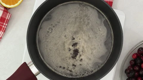 Boiling sugar syrup close up in a pan, view from above. Stock Footage 143252203