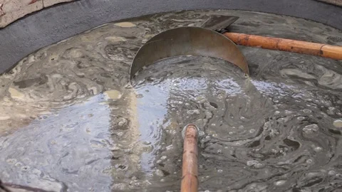 Boiling Sugarcane Juice in Large Pan for Making Jaggery in Traditional Indi.. Stock Footage 331340917