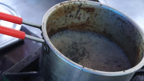 Boiling tea in a tea frying pan on a gas stove. Stock Footage 245200091