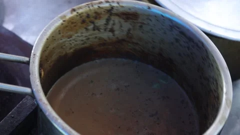 Boiling tea in a tea frying pan on a gas stove. Stock Footage 245200092
