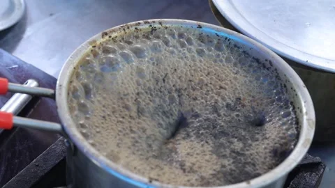 Boiling tea in a tea frying pan on a gas stove. Stock Footage 245200579