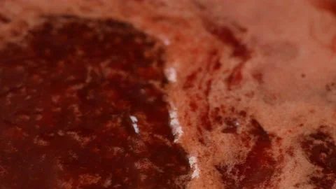 Boiling viburnum jam with pulp in a close-up. Side view. Stock Footage 165992858