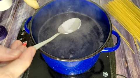 Boiling water. Adding salt Stock Footage 227722232