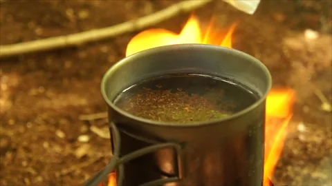 Boiling Water and Coffee over Wood Stove Campfire. Cup of Water Boiling Stock Footage 306532982