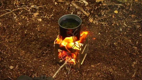 Boiling Water and Coffee over Wood Stove Campfire. Cup of Water Boiling Stock Footage 306532985