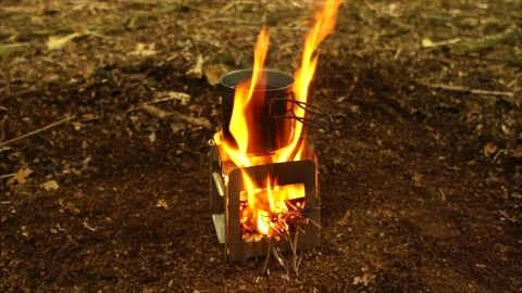 Boiling Water and Coffee over Wood Stove Campfire. Cup of Water Boiling Stock Footage 306533004