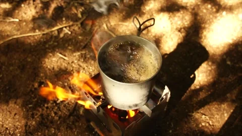 Boiling Water and Coffee over Wood Stove Campfire. Cup of Water Boiling Stock Footage 306533008