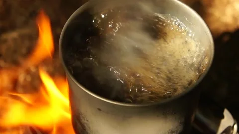 Boiling Water and Coffee over Wood Stove Campfire. Cup of Water Boiling Stock Footage 306533009
