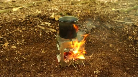 Boiling Water and Coffee over Wood Stove Campfire. Cup of Water Boiling Stock Footage 306533016